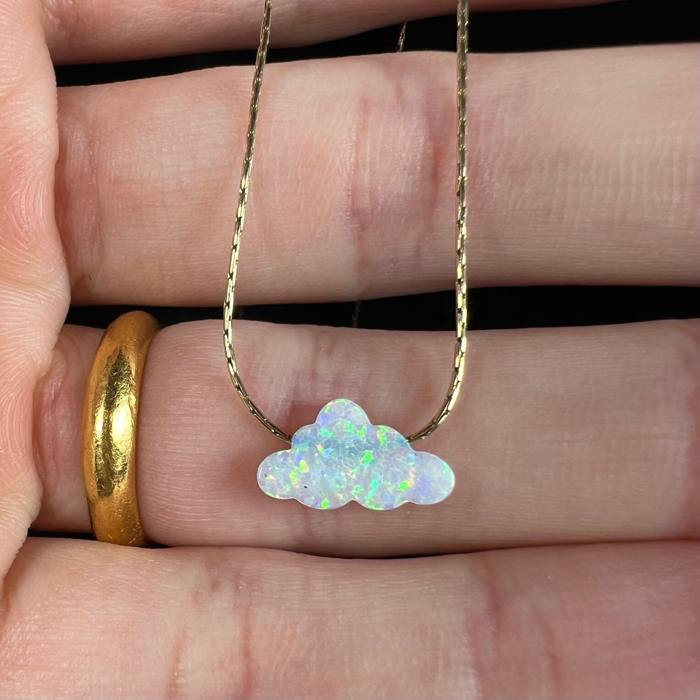 A lab-created opal cloud necklace on a gold filled chain.