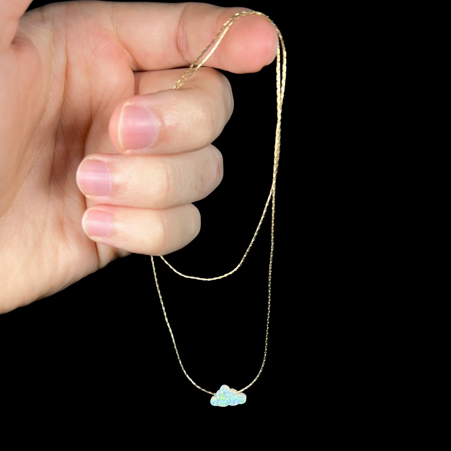 A lab-created opal cloud necklace on a gold filled chain.
