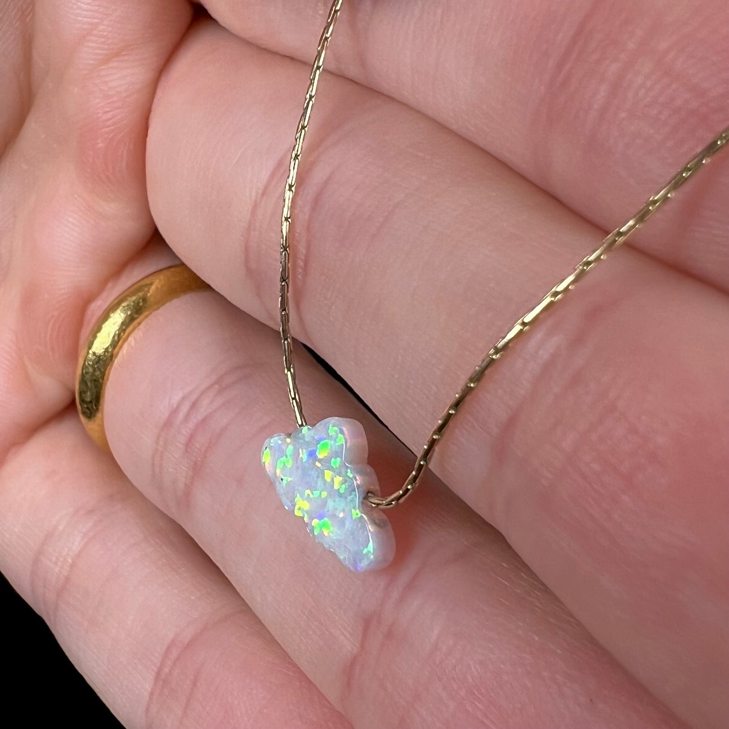 A lab-created opal cloud necklace on a gold filled chain.