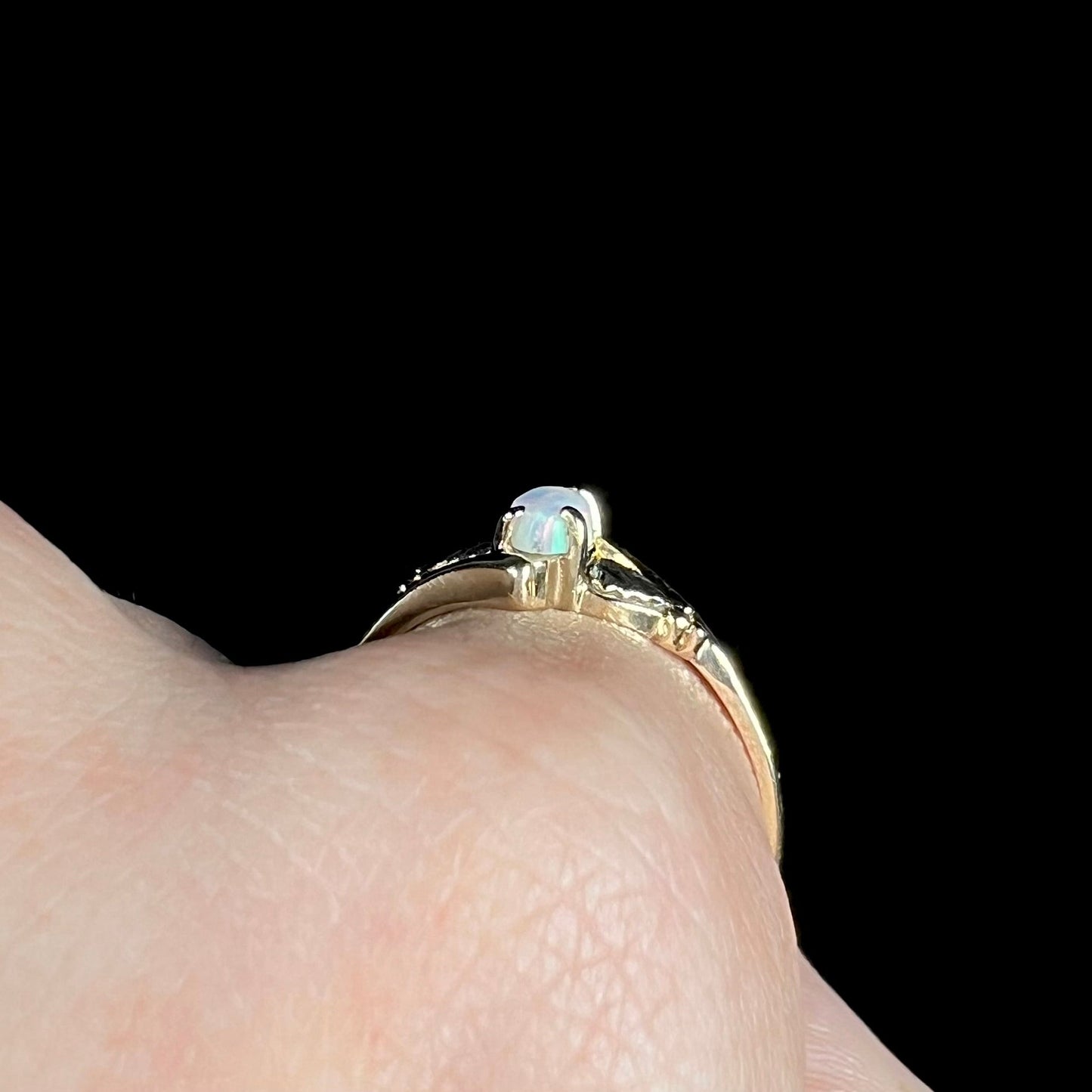 A vintage Blach Hills gold ring mounted with a marquise cut lab created opal.