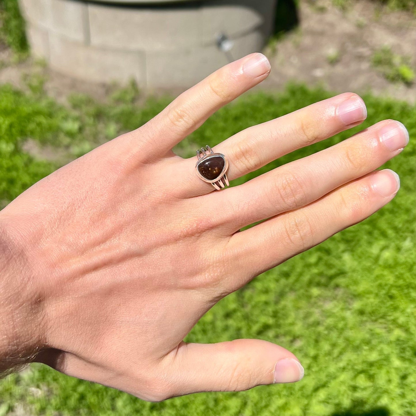 A ladies' freeform cabochon cut fire agate ring in sterling silver.