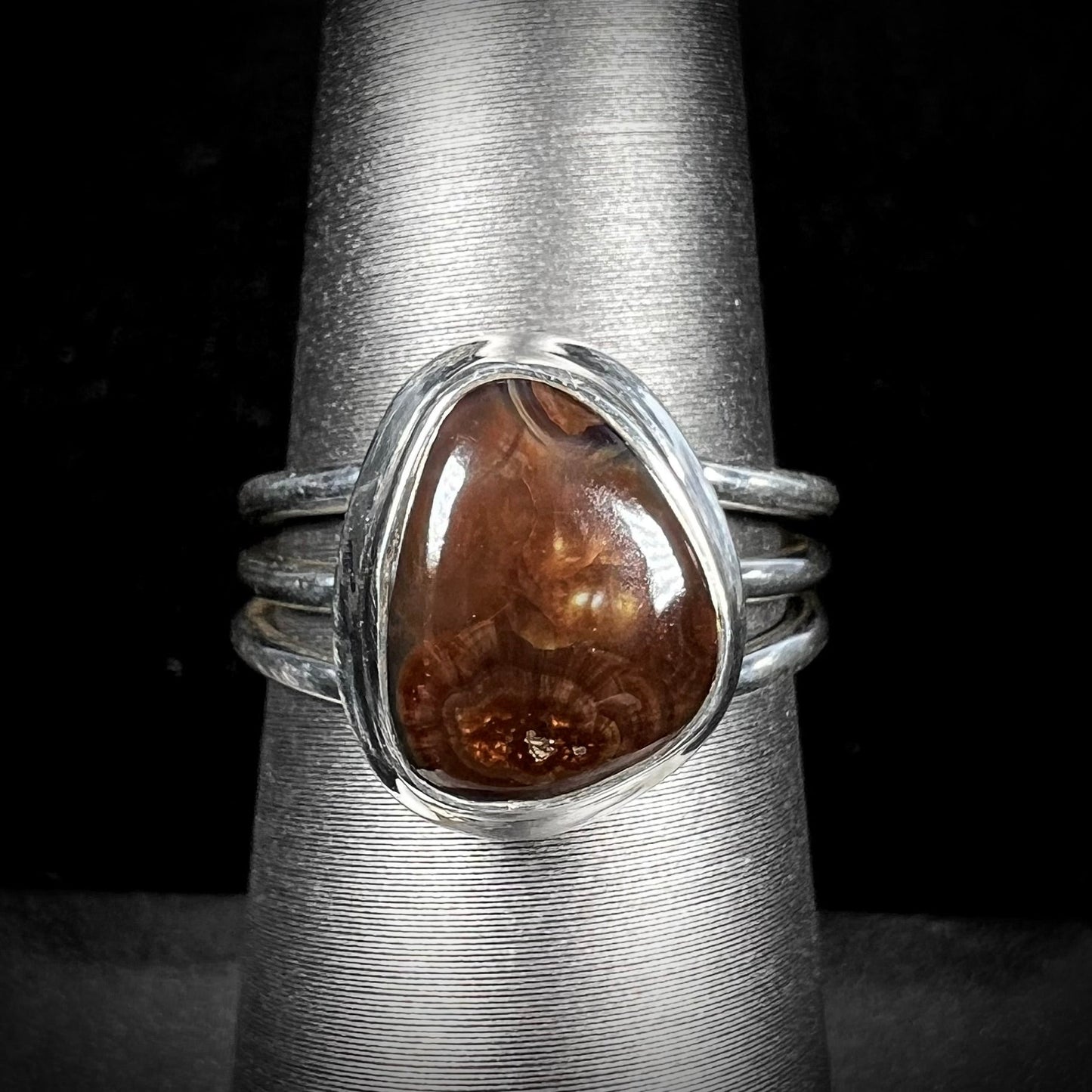 A ladies' fire agate ring set in a split-shank sterling silver mounting.