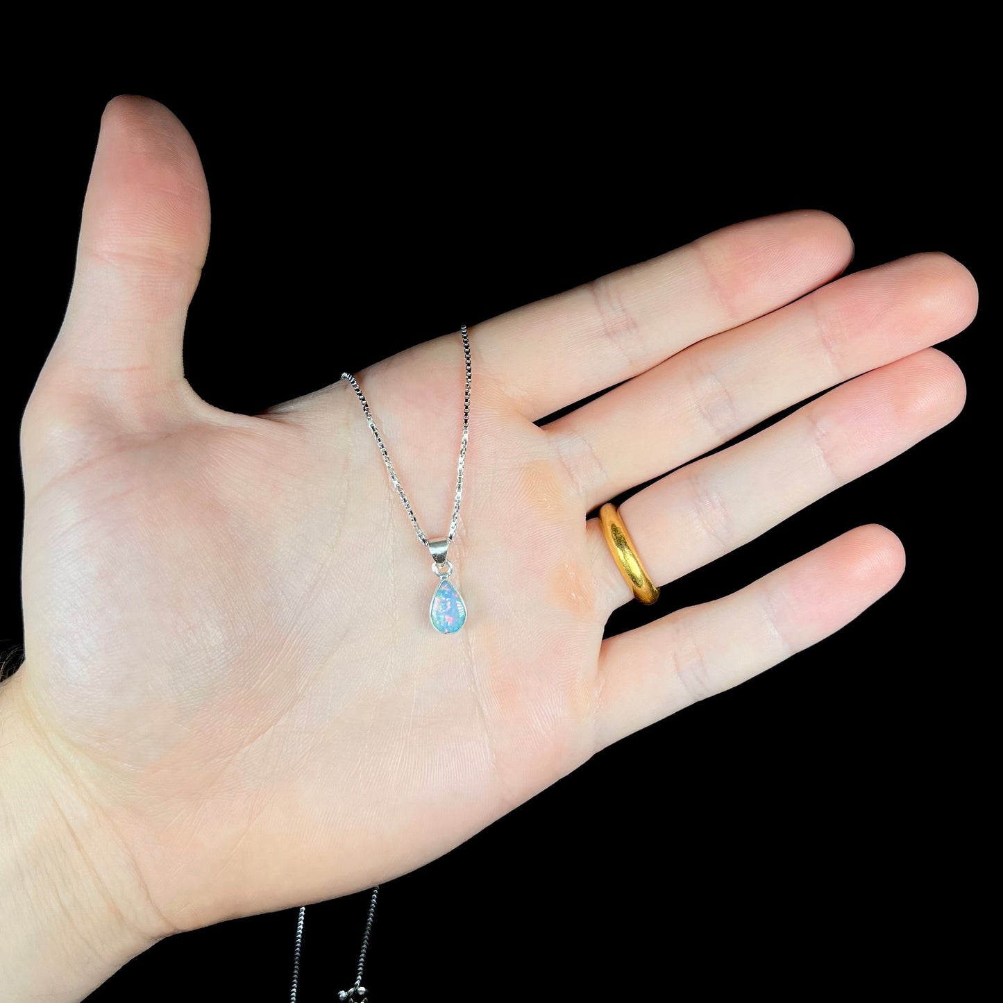 A pear shaped natural crystal opal necklace handmade in sterling silver.