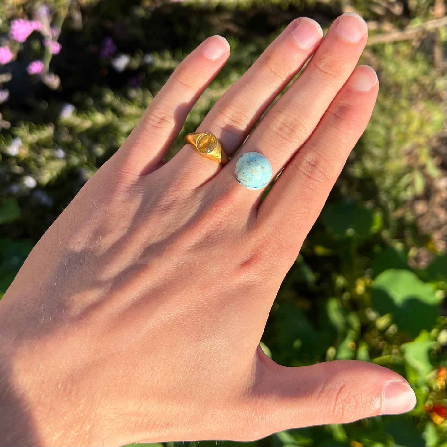 A loose, round cabochon cut Valley Blue turquoise stone.
