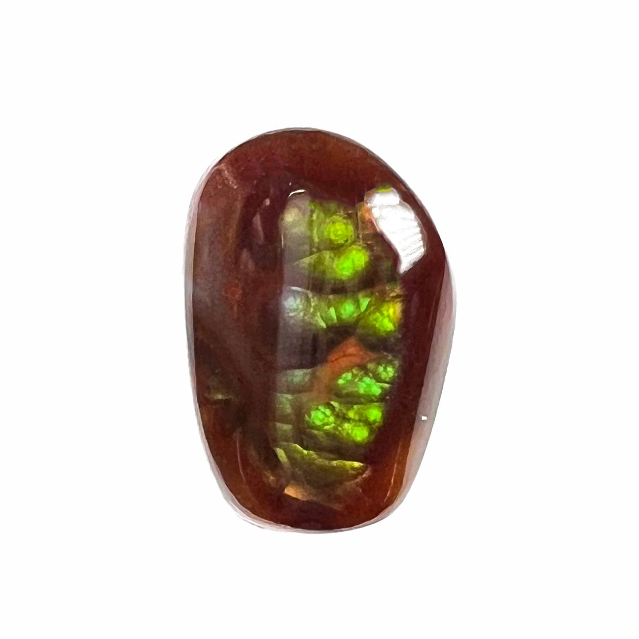 A loose, freeform cabochon cut fire agate gemstone. The stone is green with blue overtones.