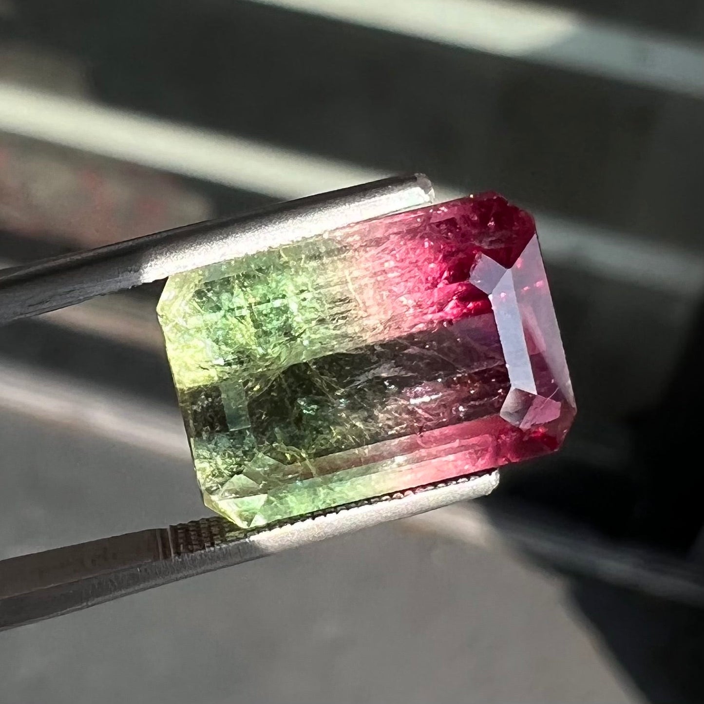 A loose pink and green emerald cut watermelon tourmaline gemstone.