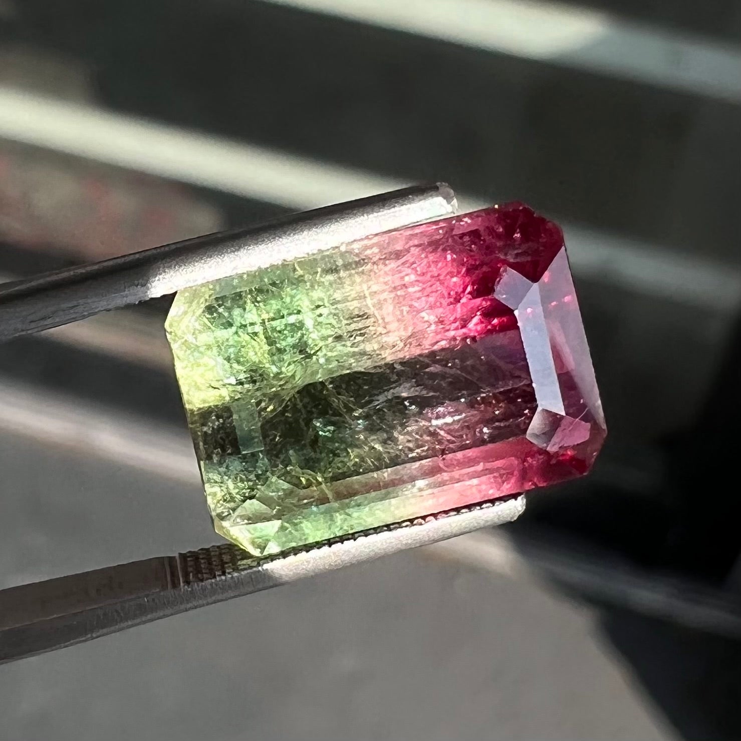 A loose pink and green emerald cut watermelon tourmaline gemstone.