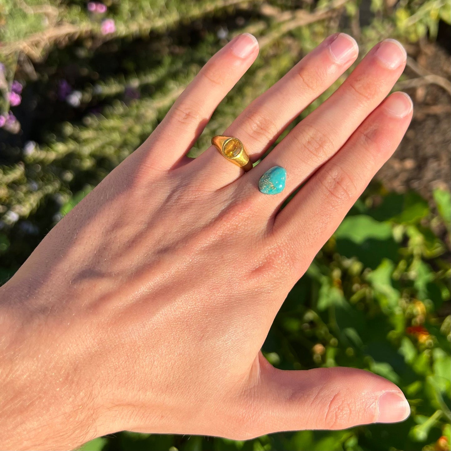 A loose, freeform cut Pilot Mountain turquoise cabochon. The stone is greenish blue.