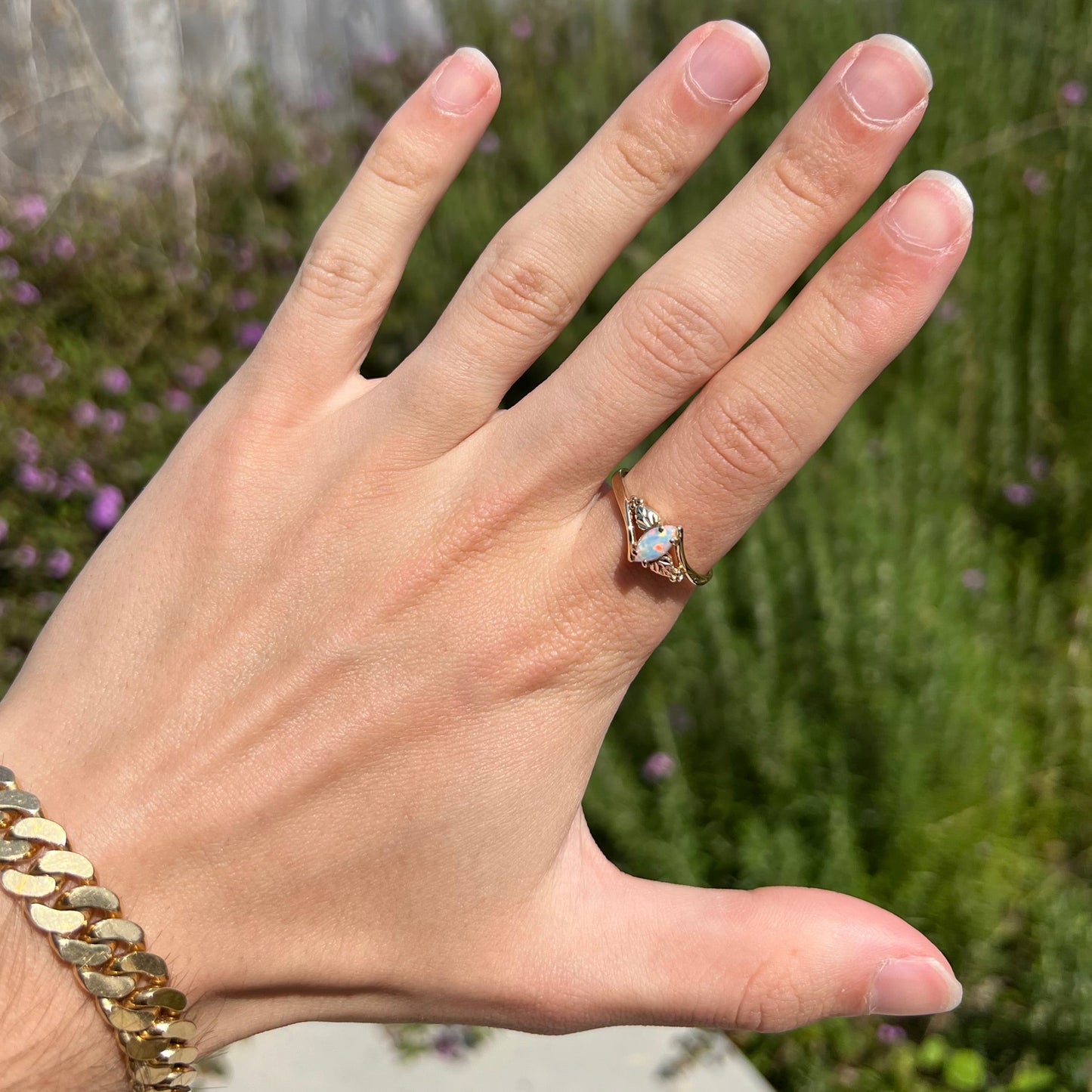 A vintage Blach Hills gold ring mounted with a marquise cut lab created opal.