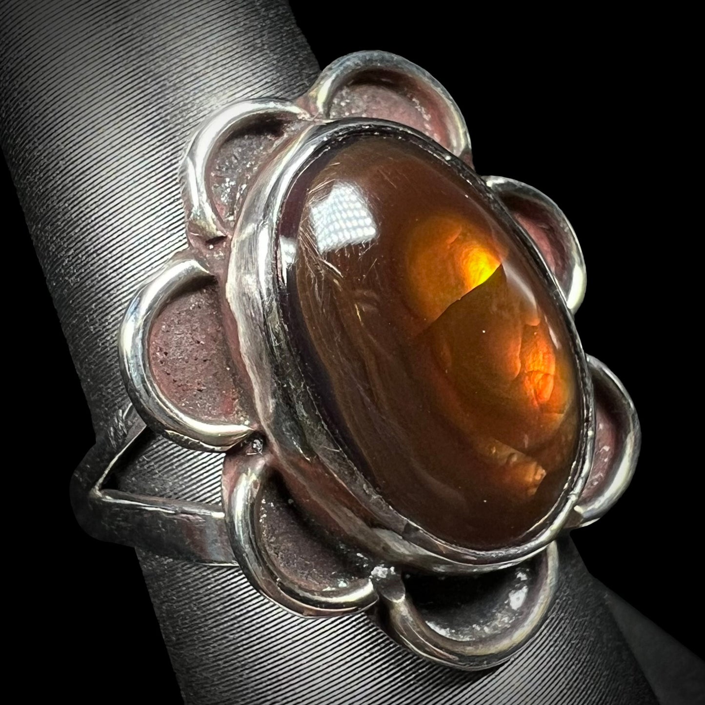 Fire agate ring showing brown stone with orange and yellow flashes.