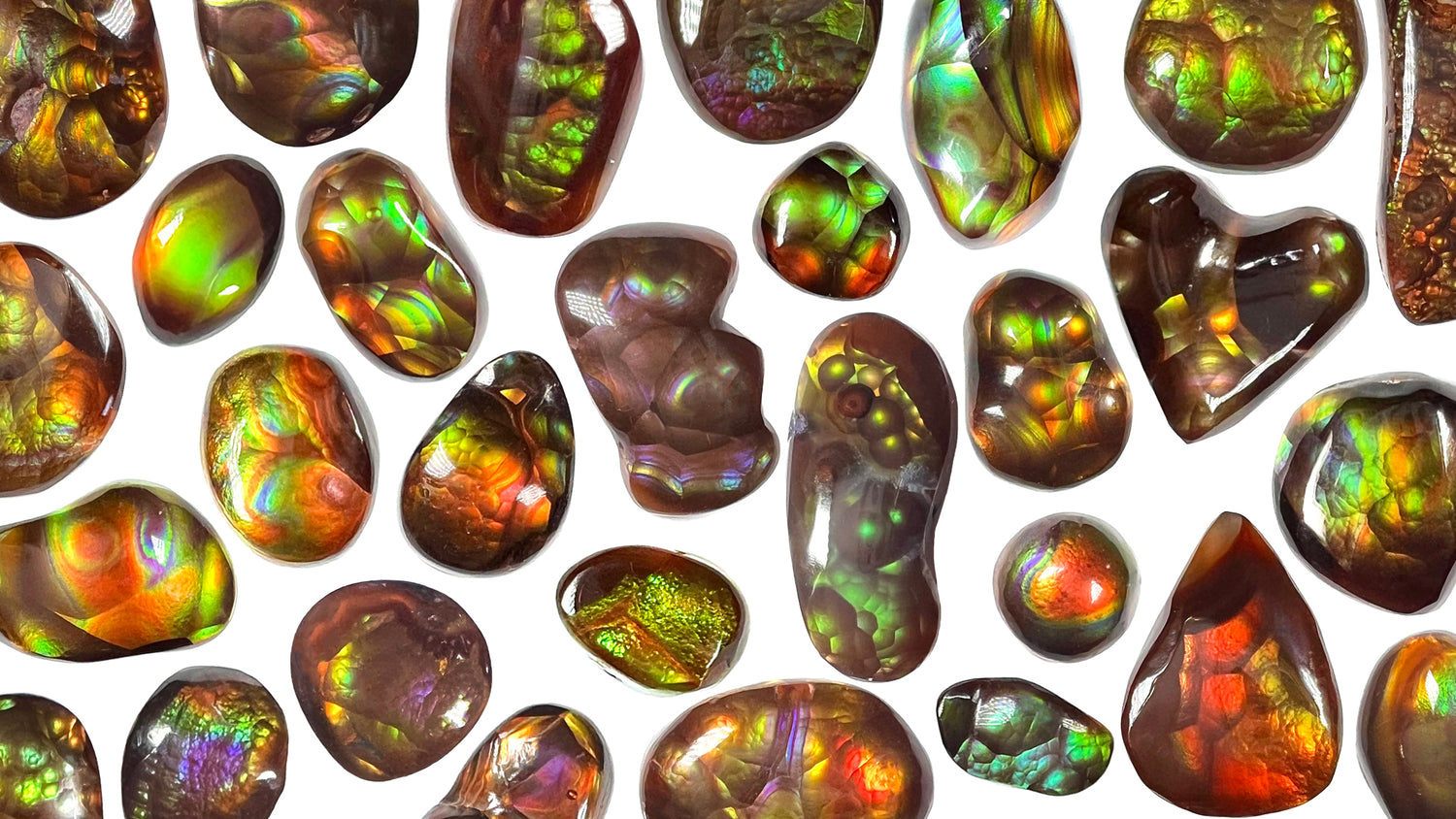 A collection of colorful Mexican fire agate stones on a white background.