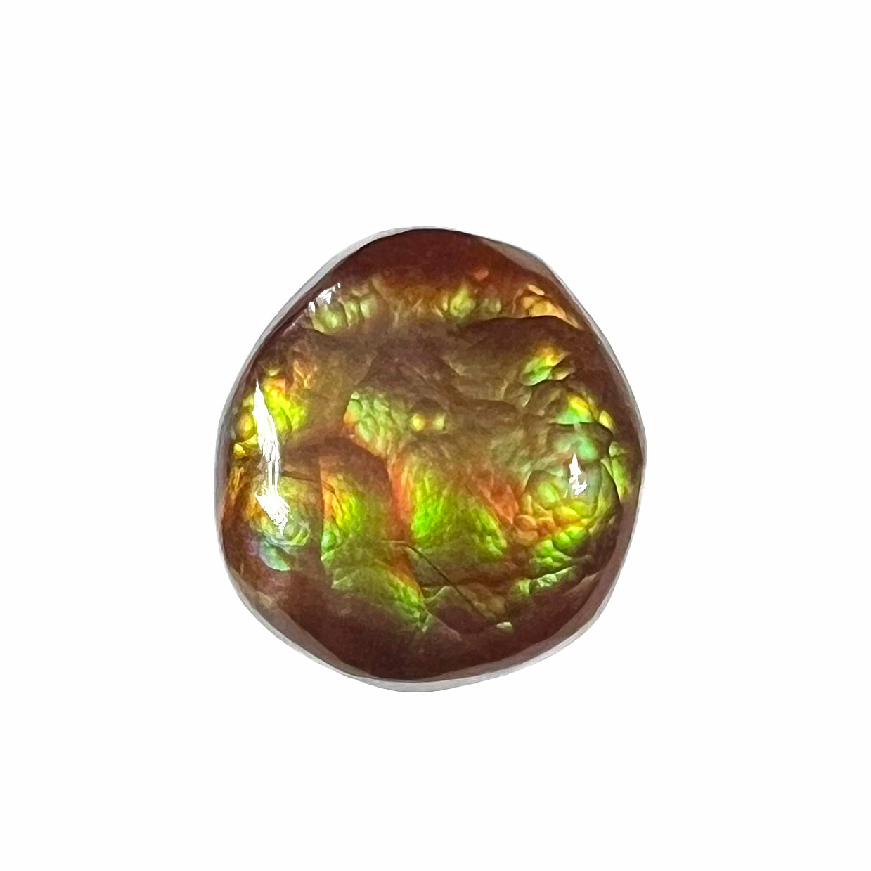 An iridescent green, yellow, and red Mexican fire agate stone. The stone is an off-round cabochon.