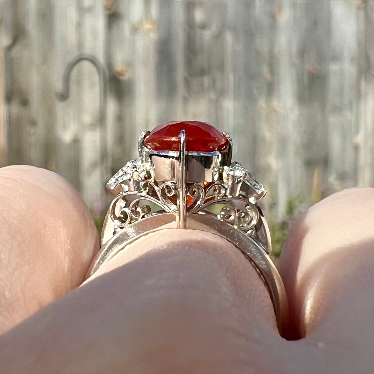 The gallery view of a Japanese Mid-Century style fire opal ring, showcasing open platinum filigree.