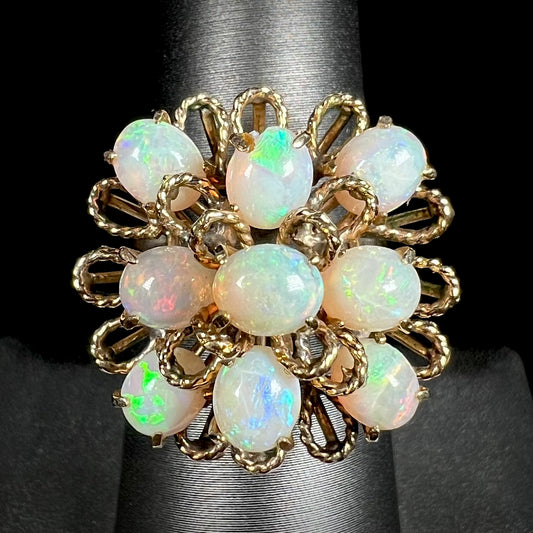 A ladies' yellow gold opal cluster ring.  The ring is an atomic motif, handmade in the mid-century modern style.