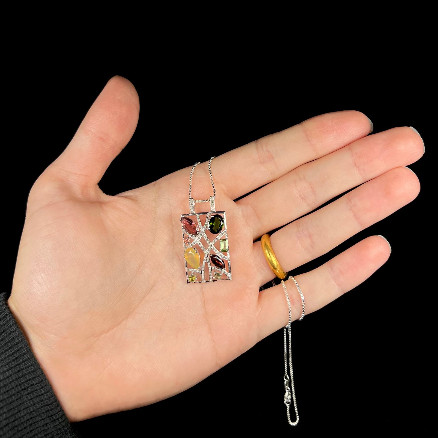 A sterling silver multi-gemstone necklace set with Ethiopian opal, tourmaline, and diamonds.