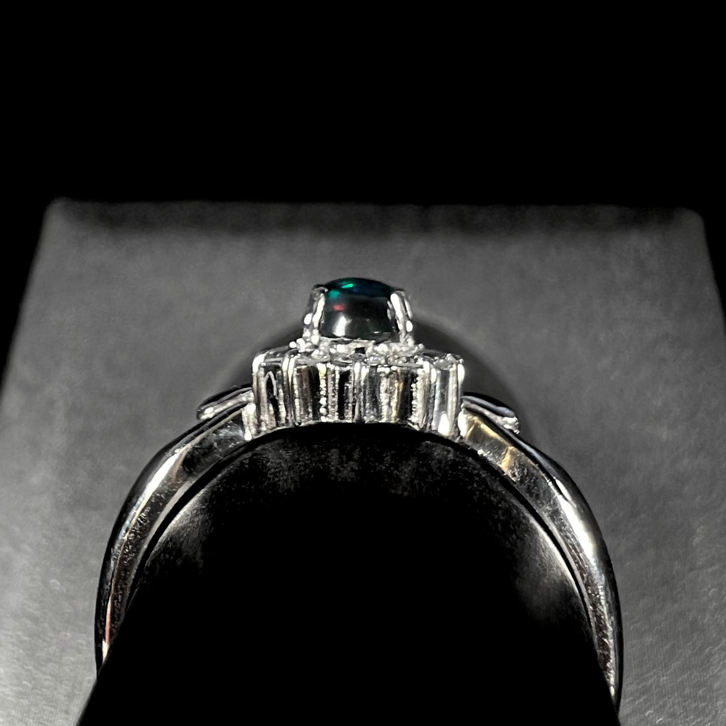 Gallery view of black opal ring showing two green flashes and one red flash in opal.