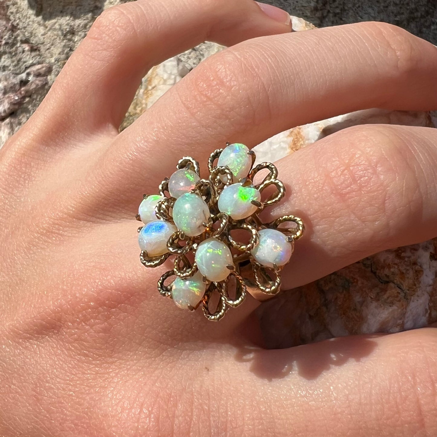 A ladies' yellow gold opal cluster ring. The ring is an atomic motif, handmade in the mid-century modern style.