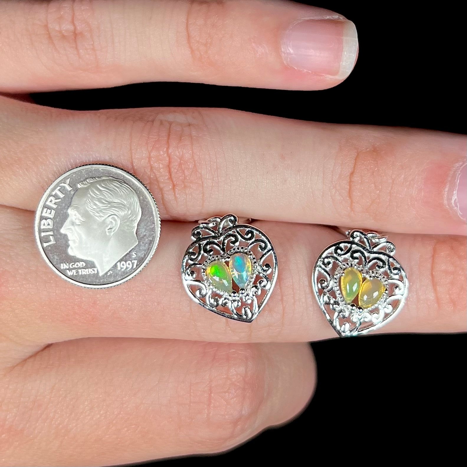 A pair of dangling sterling silver filigree heart earrings, each set with two Ethiopian opals.