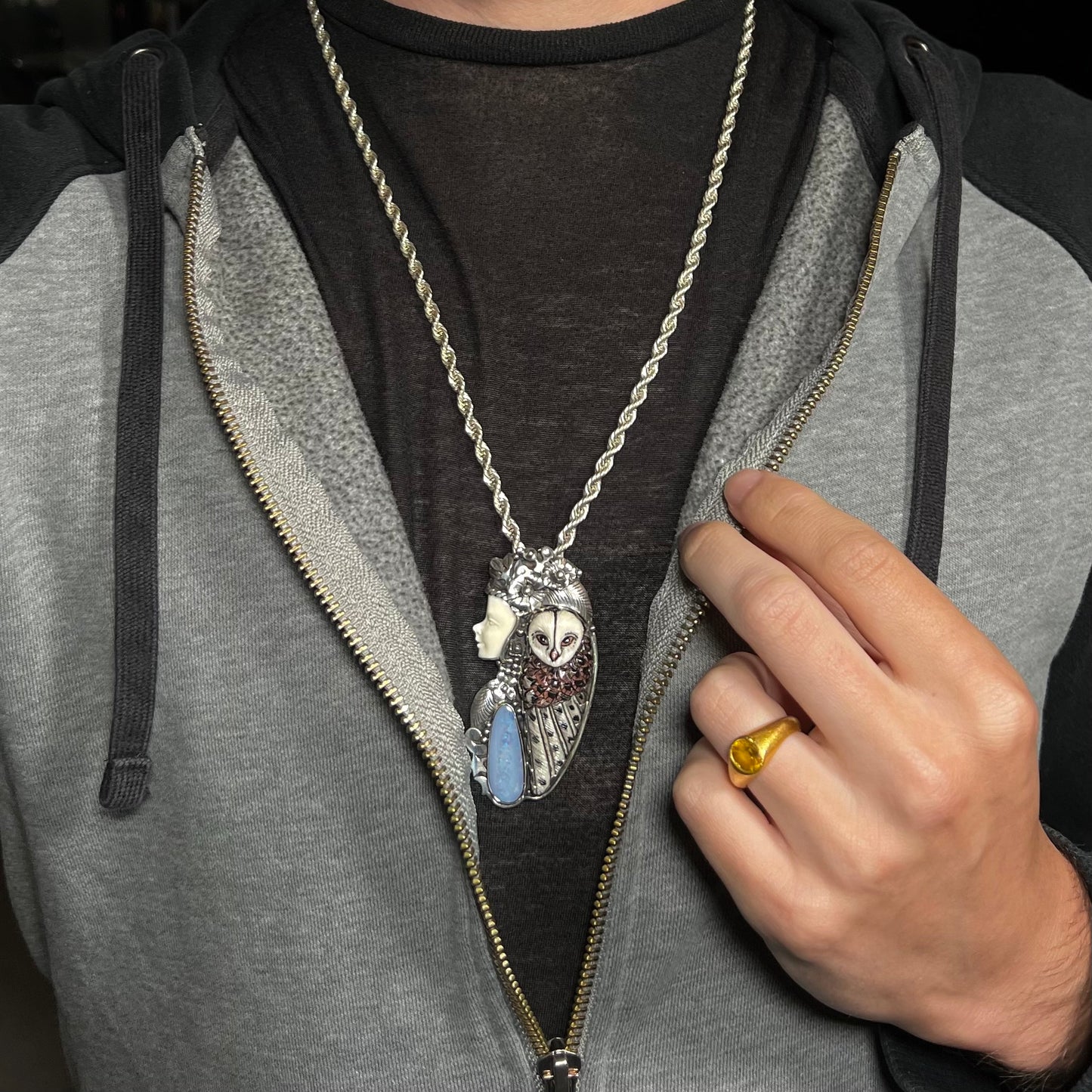 A woman and owl necklace with a nature-inspired motif, made from sterling silver, bone, and an opal doublet.