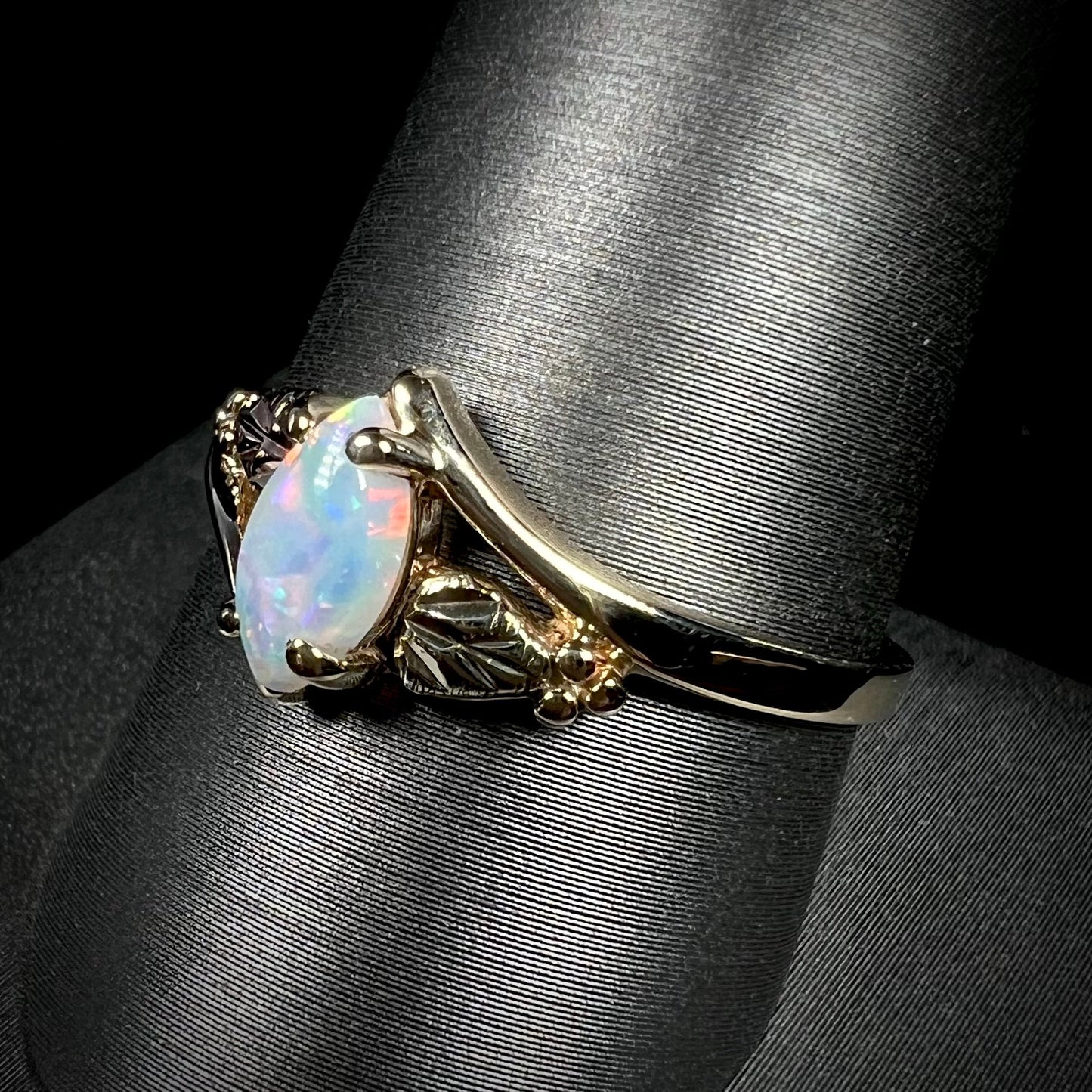 A vintage Blach Hills gold ring mounted with a marquise cut lab created opal.