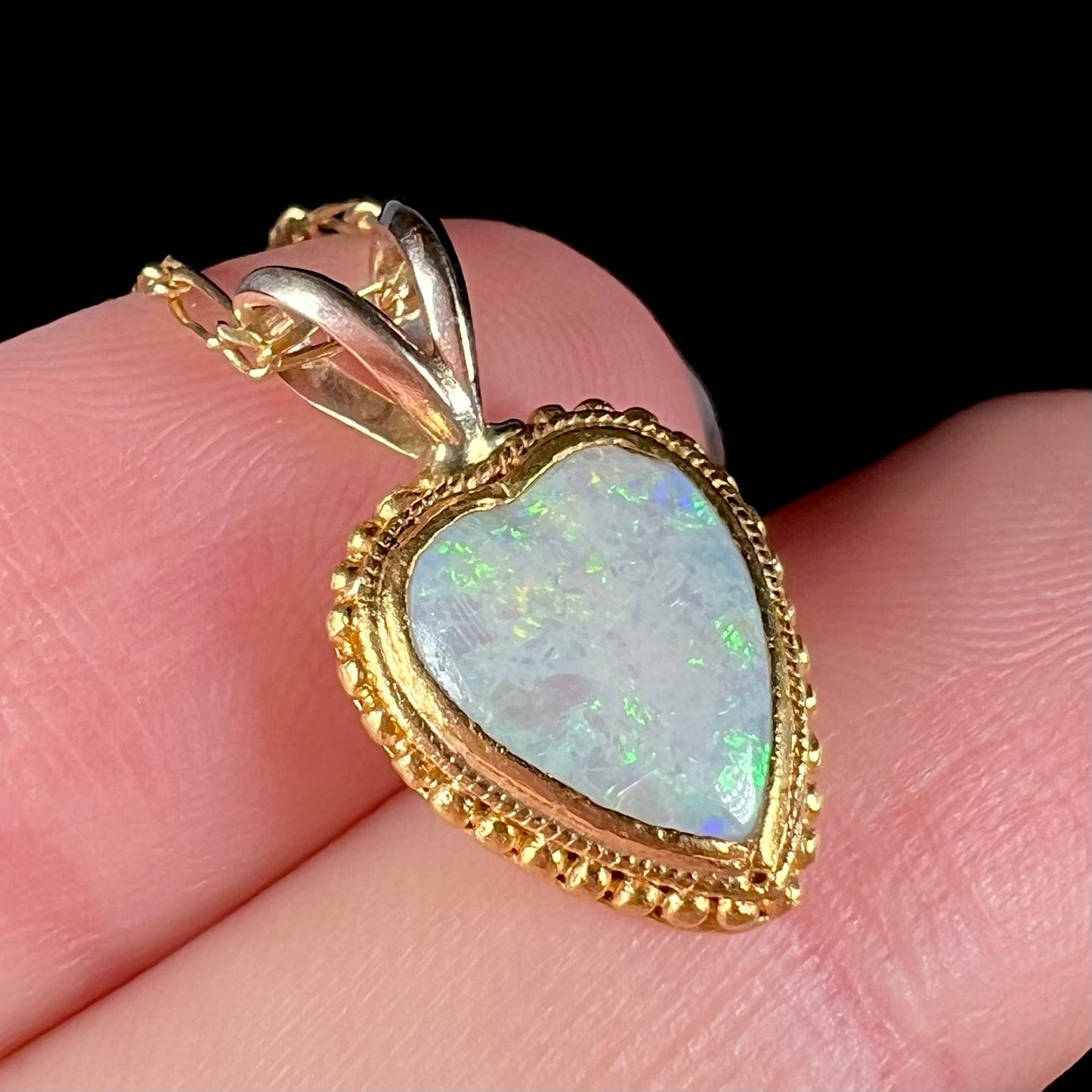 An 18 karat yellow gold heart necklace mounted with a heart shaped opal.