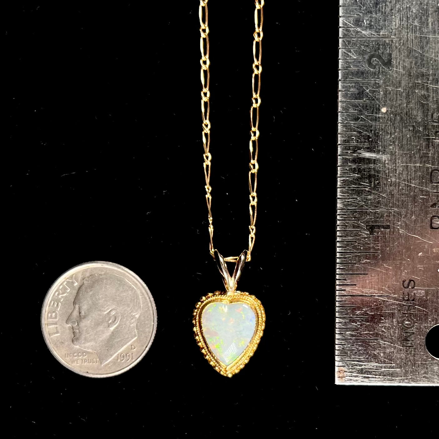 An 18 karat yellow gold heart necklace mounted with a heart shaped opal.