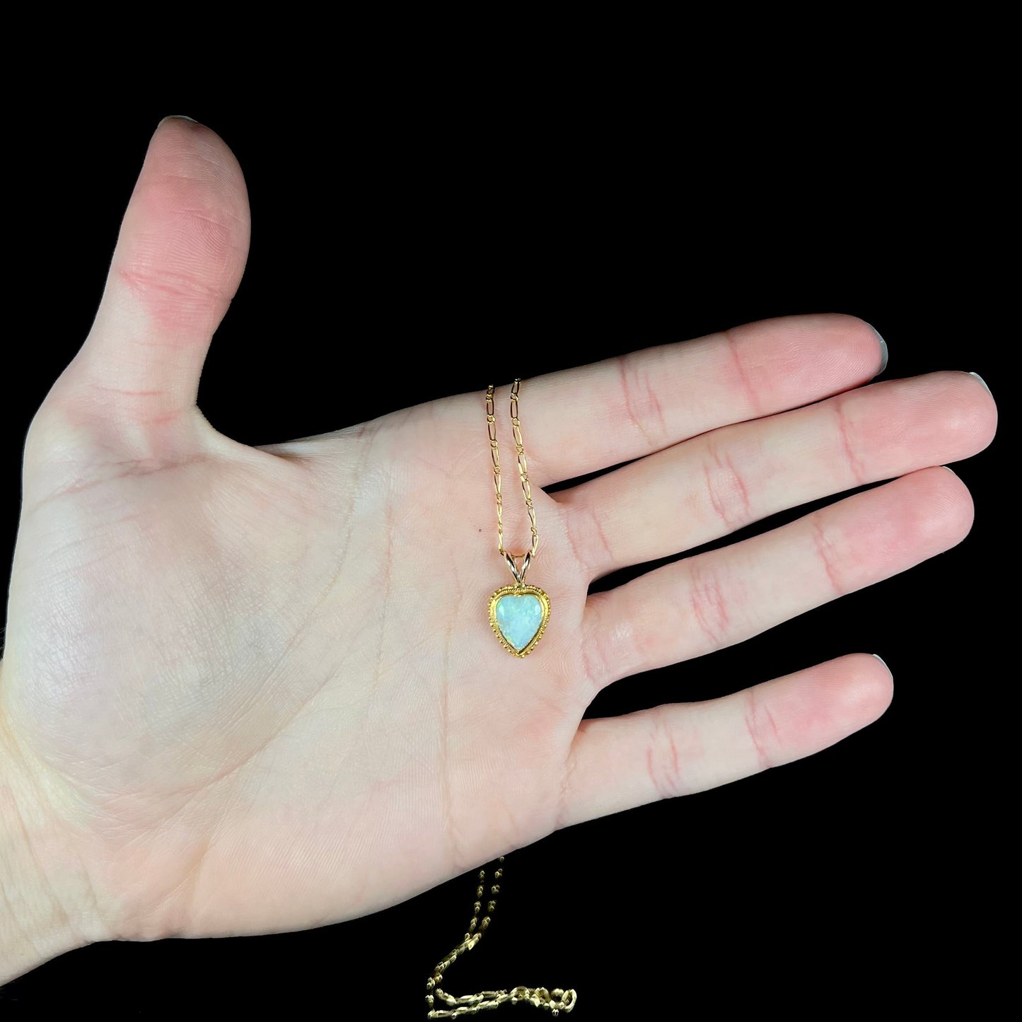 An 18 karat yellow gold heart necklace mounted with a heart shaped opal.