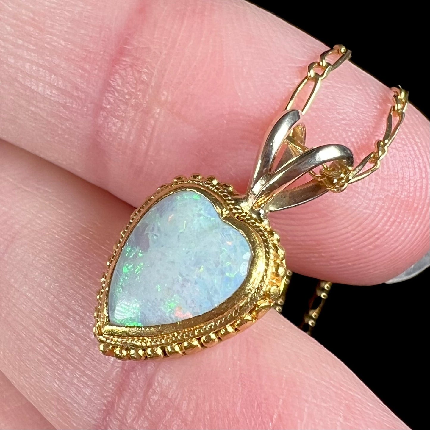 An 18 karat yellow gold heart necklace mounted with a heart shaped opal.