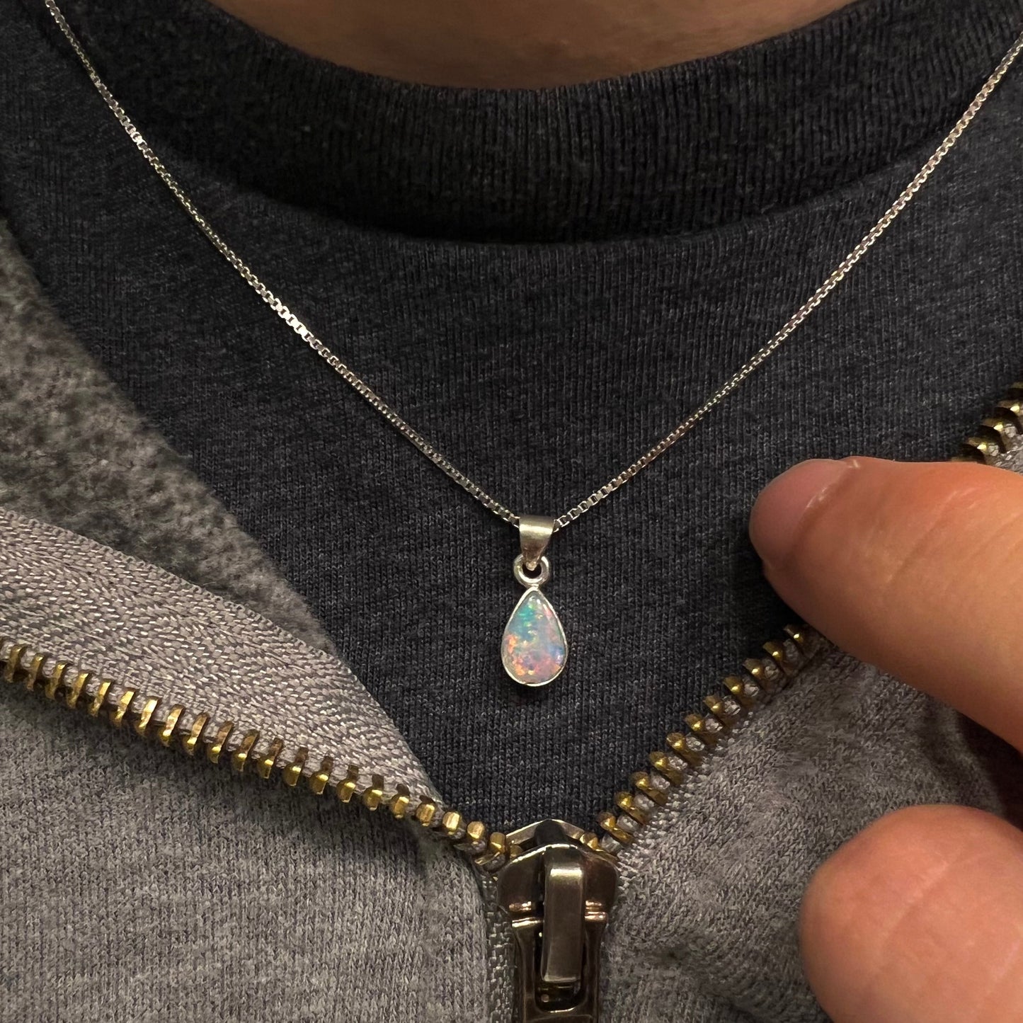 A pear shaped natural crystal opal necklace handmade in sterling silver.