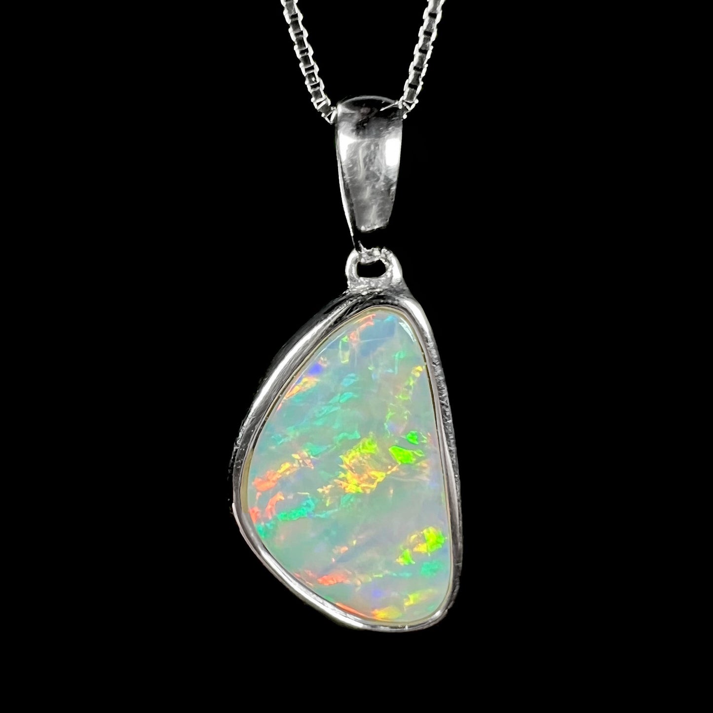 A sterling silver pendant bezel set with a white Australian crystal opal on a box chain.