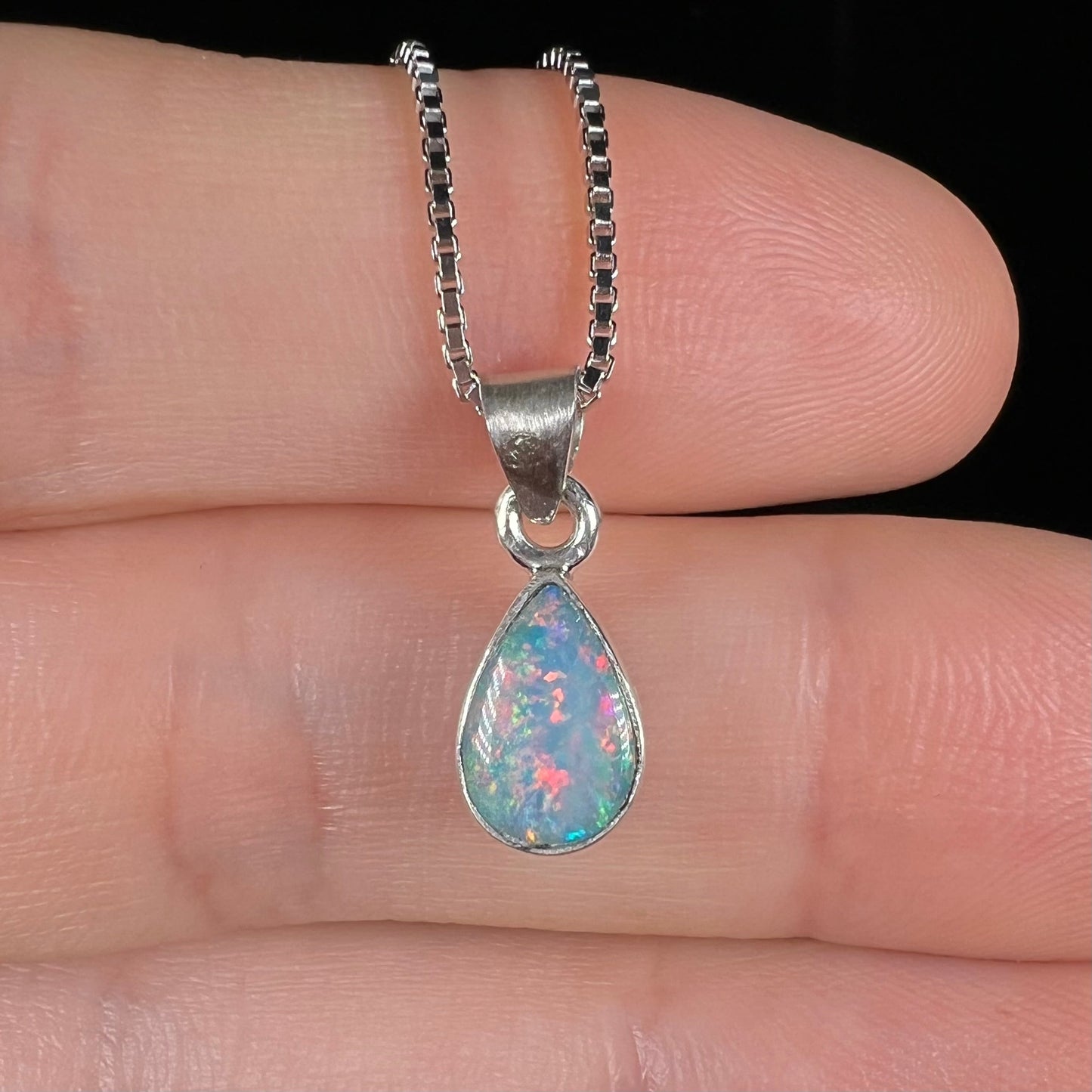 A pear shaped natural crystal opal necklace handmade in sterling silver.