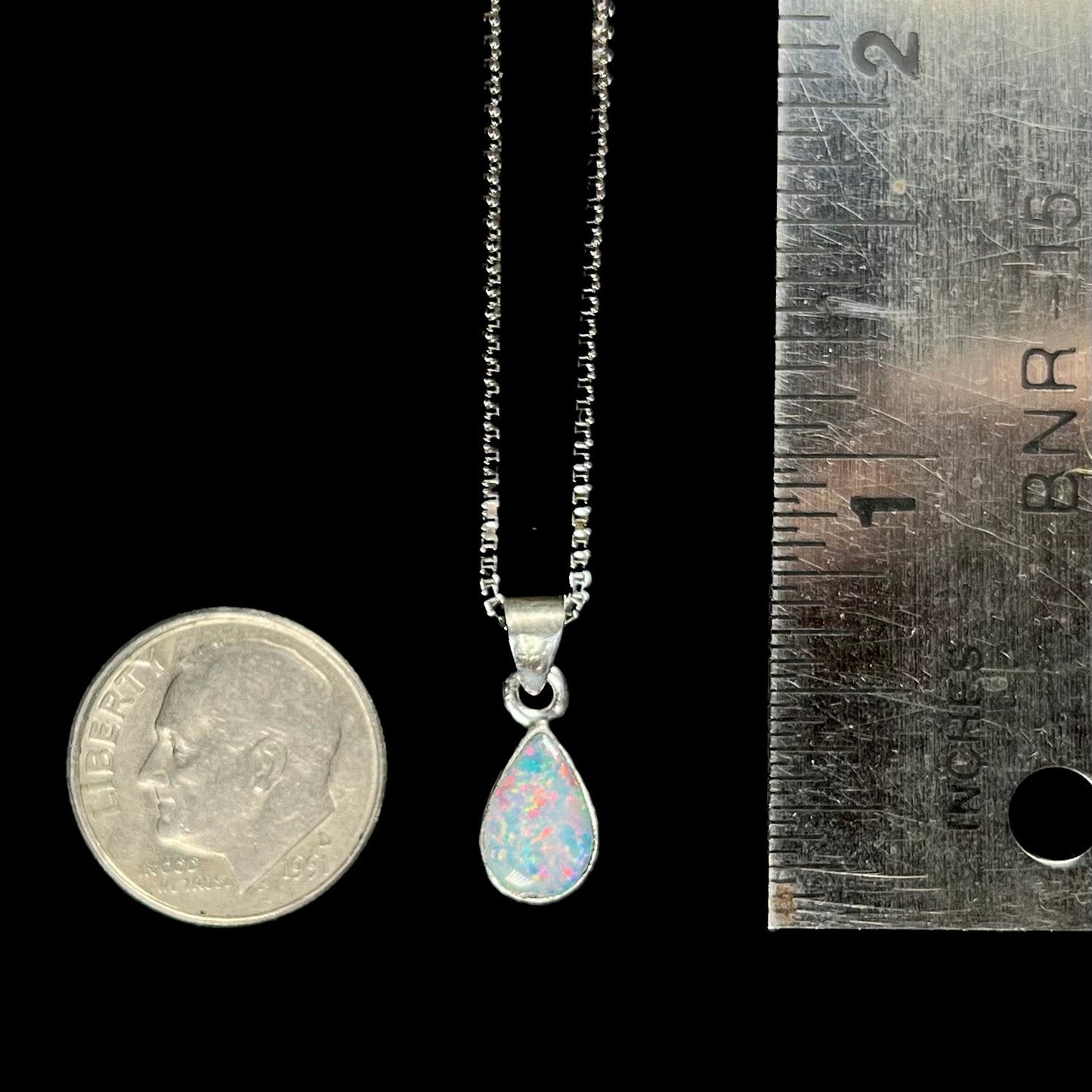 A pear shaped natural crystal opal necklace handmade in sterling silver.