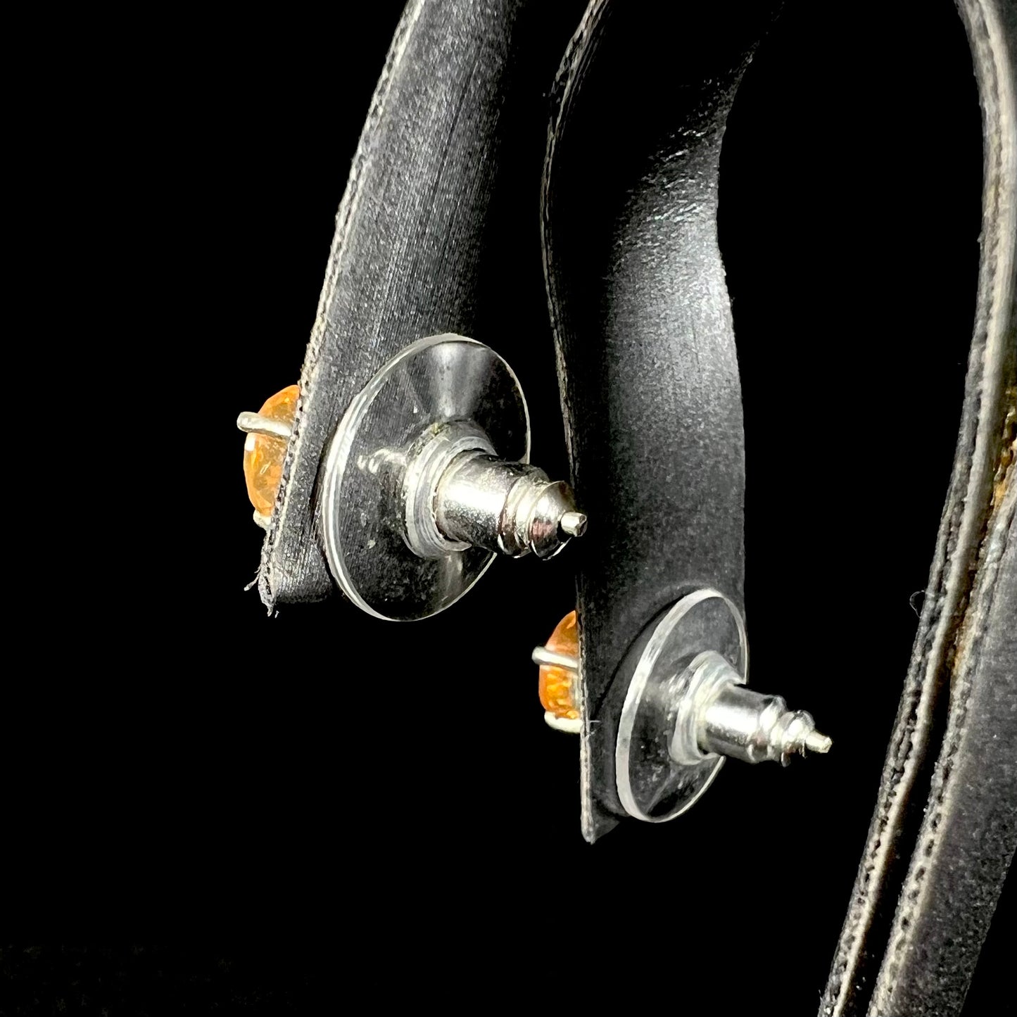 Back view of Mexican fire opal stud earrings in sterling silver, showing the plastic disk backs.