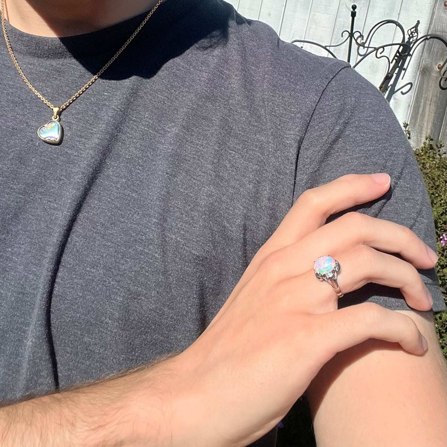 A platinum and diamond ring prong-set with an Australian opal. The opal has pink color play.