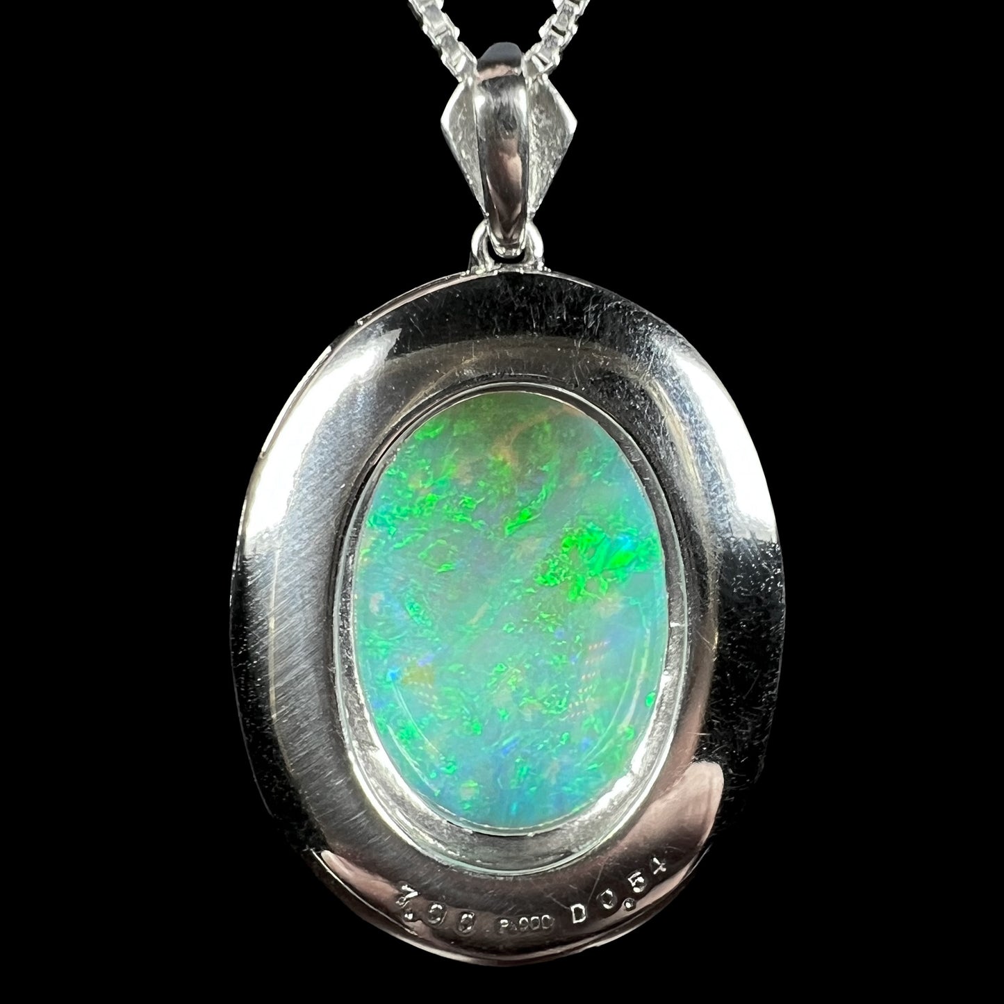 Reverse side of platinum opal pendant showing “7.00”, “Pt900”, and “D0.54” hallmark stamps.