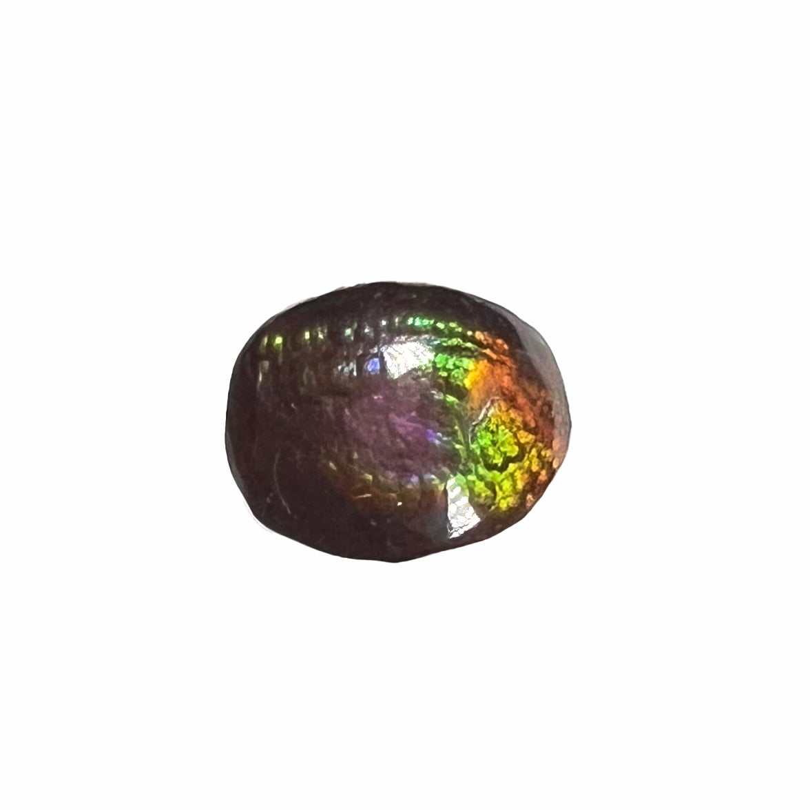 A loose, oval cabochon cut fire agate stone from Mexico. The stone has an iridescent purple and teal blue eye of color.