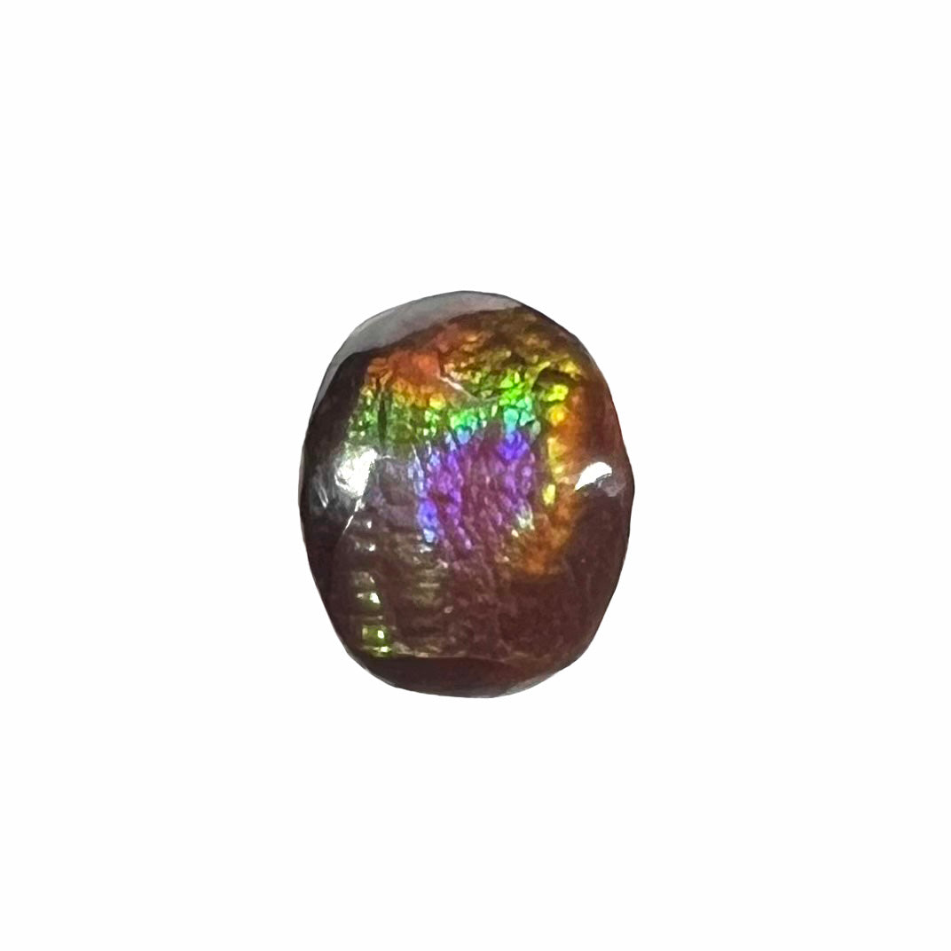 A loose, oval cabochon cut fire agate stone from Mexico. The stone has an iridescent purple and teal blue eye of color.