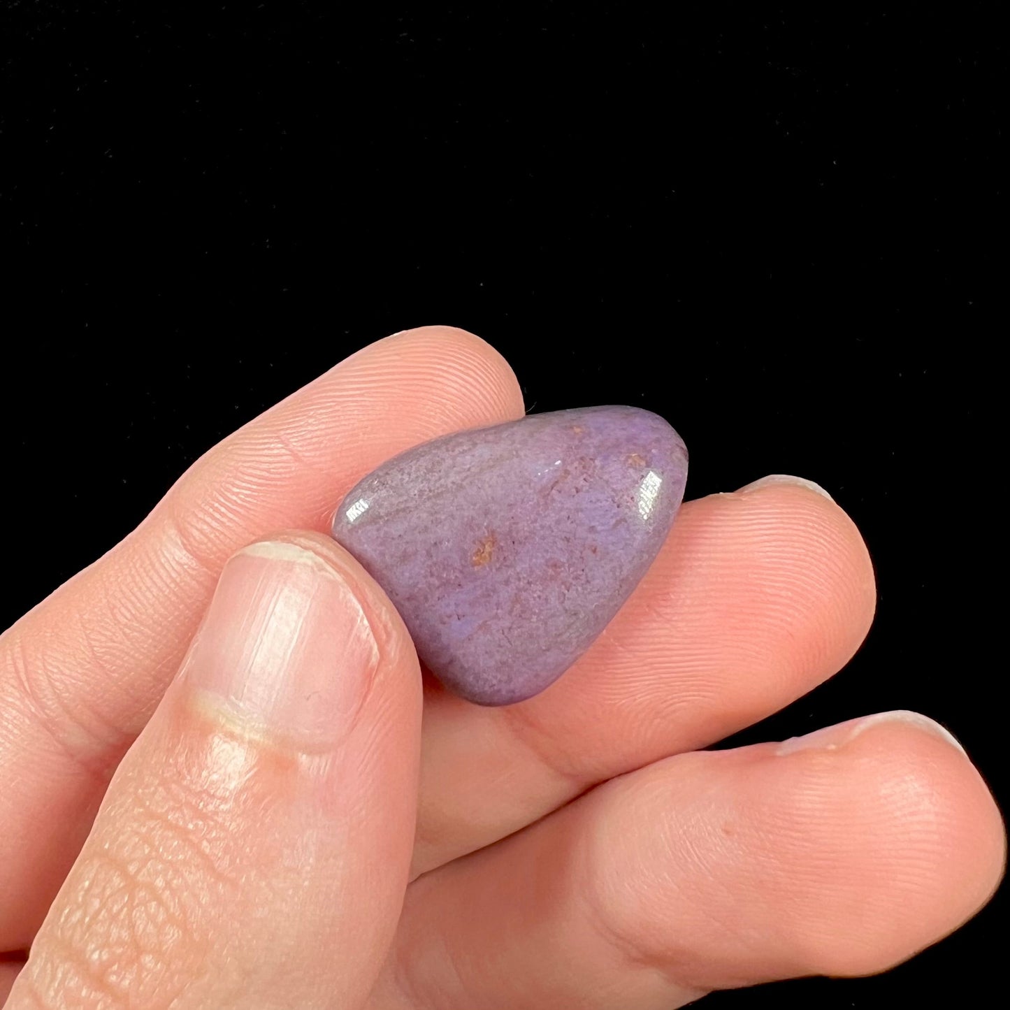 A tumbled purple turkiyenite jade stone from Borsa, Turkey. The stone has a green jadeite inclusion.