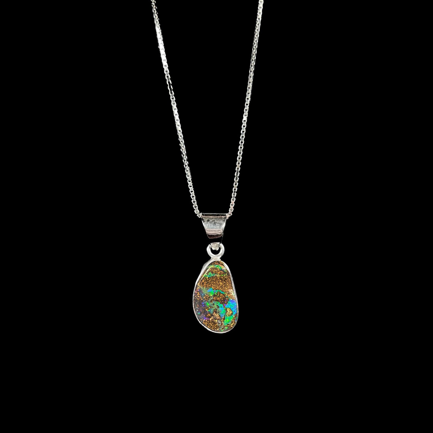 A sterling silver pendant set with an Australian boulder opal on a silver box chain.