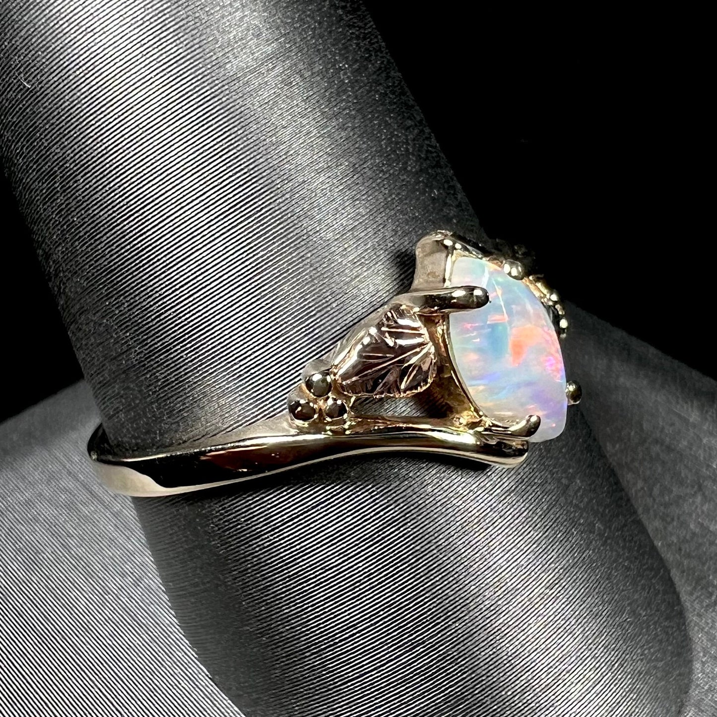 A vintage Blach Hills gold ring mounted with a marquise cut lab created opal.