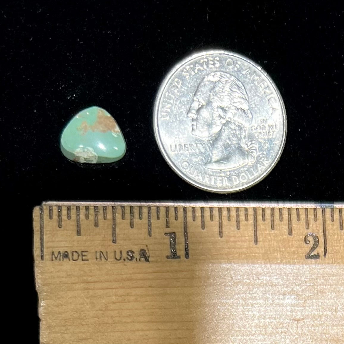 A loose, green Royston turquoise stone. The stone has a brown matrix.
