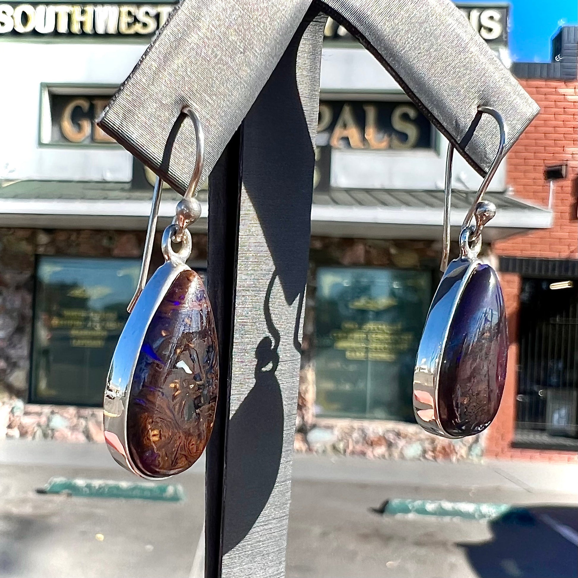 A pair of handmade sterling silver boulder opal French wire dangle earrings.  We named them Ryan and Harris.