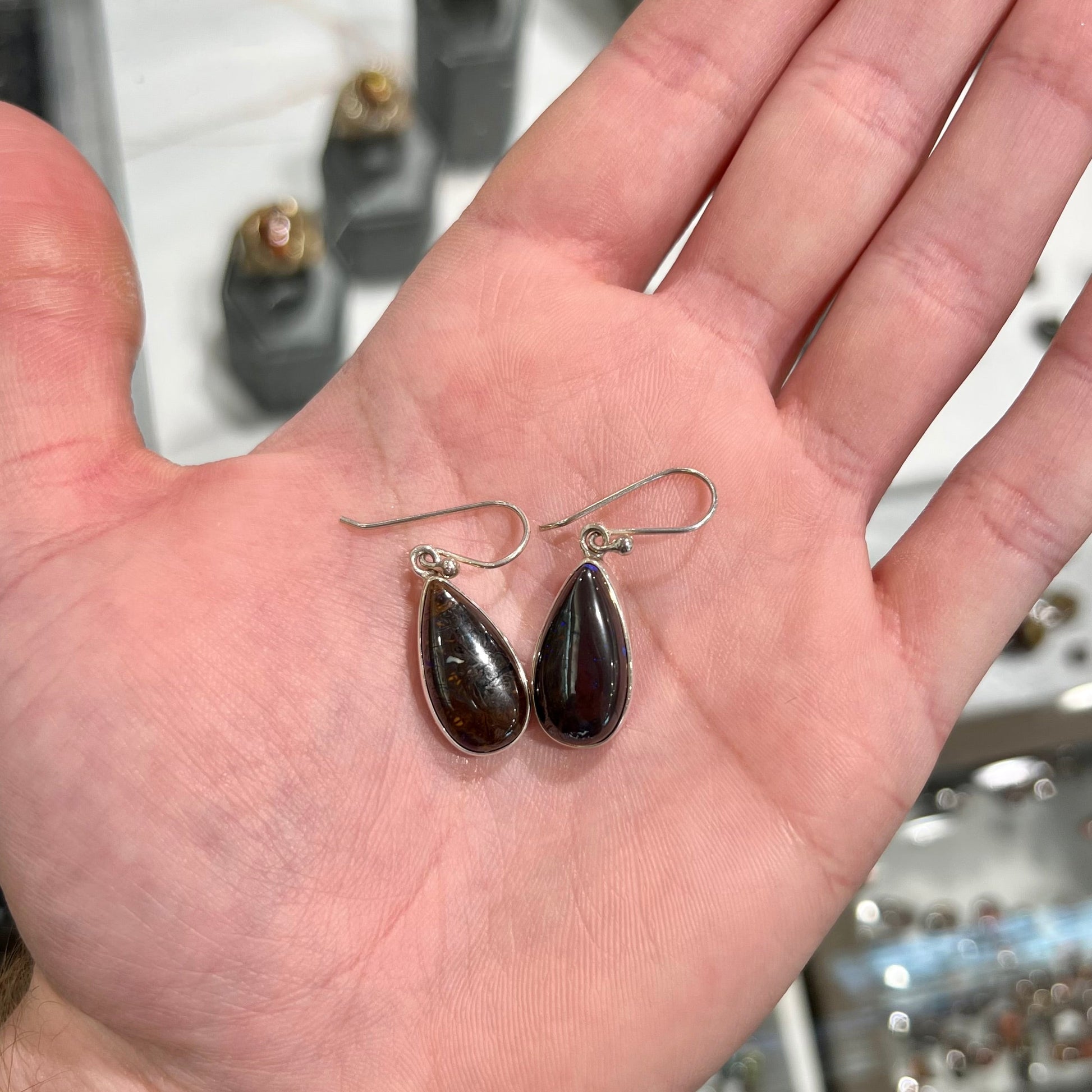A pair of handmade sterling silver boulder opal French wire dangle earrings.  We named them Ryan and Harris.