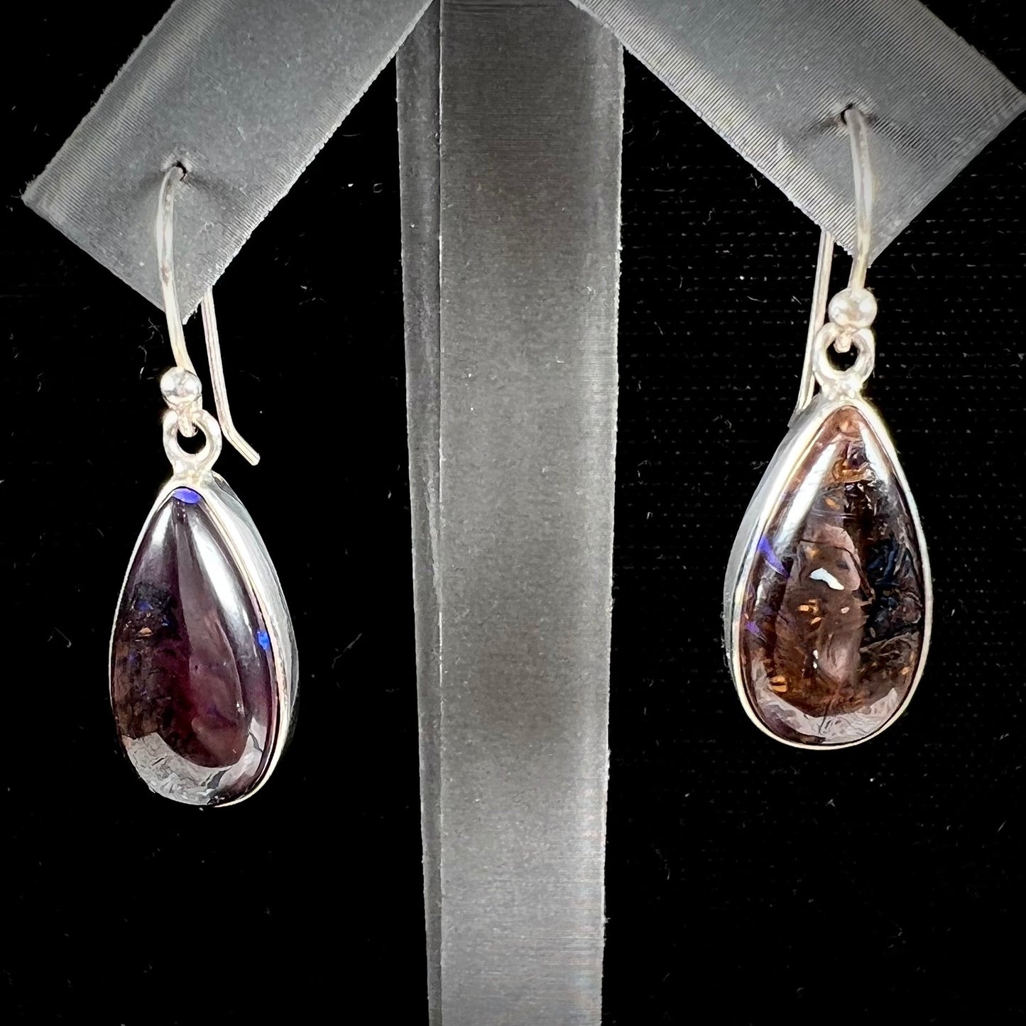 A pair of handmade sterling silver boulder opal French wire dangle earrings.  We named them Ryan and Harris.