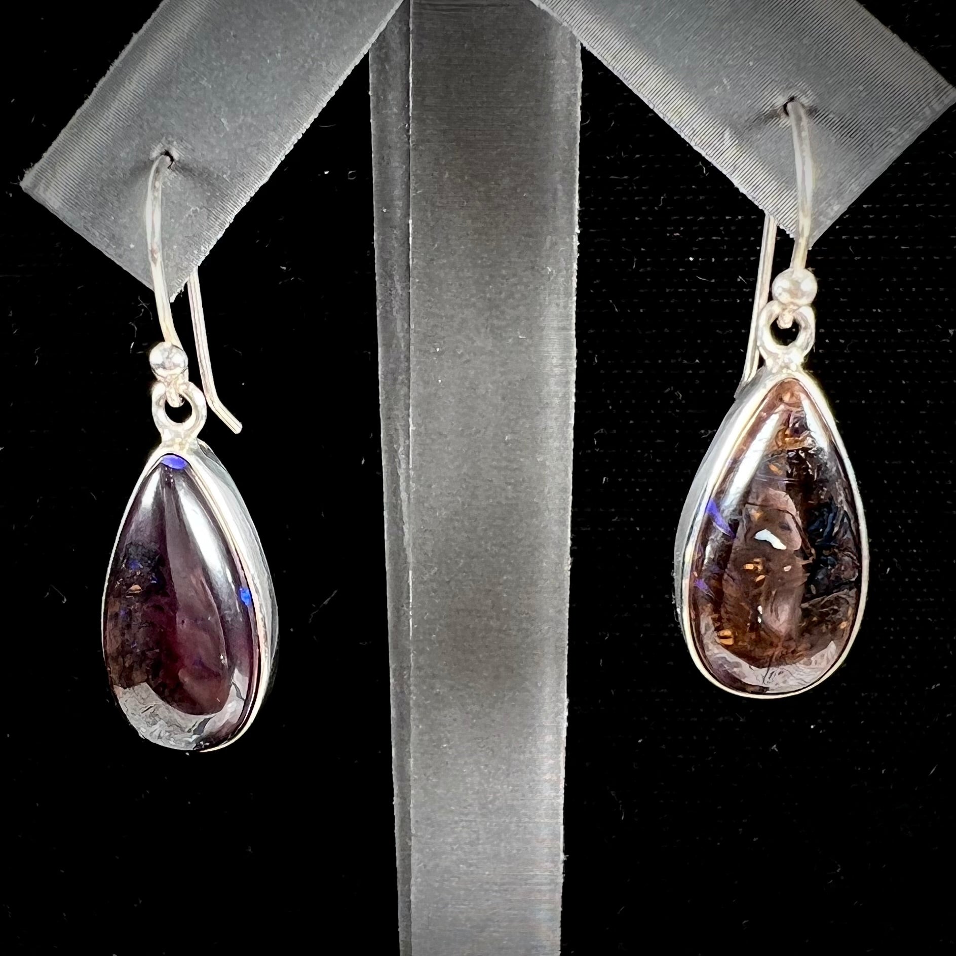 A pair of handmade sterling silver boulder opal French wire dangle earrings.  We named them Ryan and Harris.