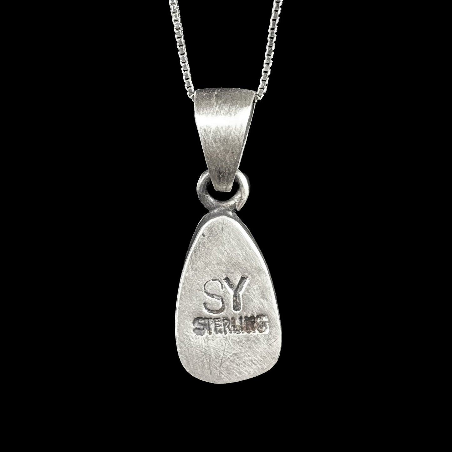 A handmade, satin finish sterling silver pendant set with a drop shaped boulder opal stone.