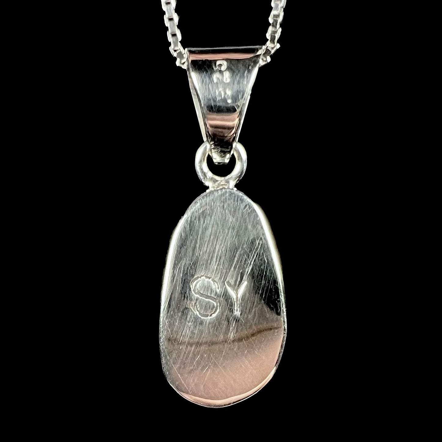A sterling silver pendant set with an Australian boulder opal on a silver box chain.