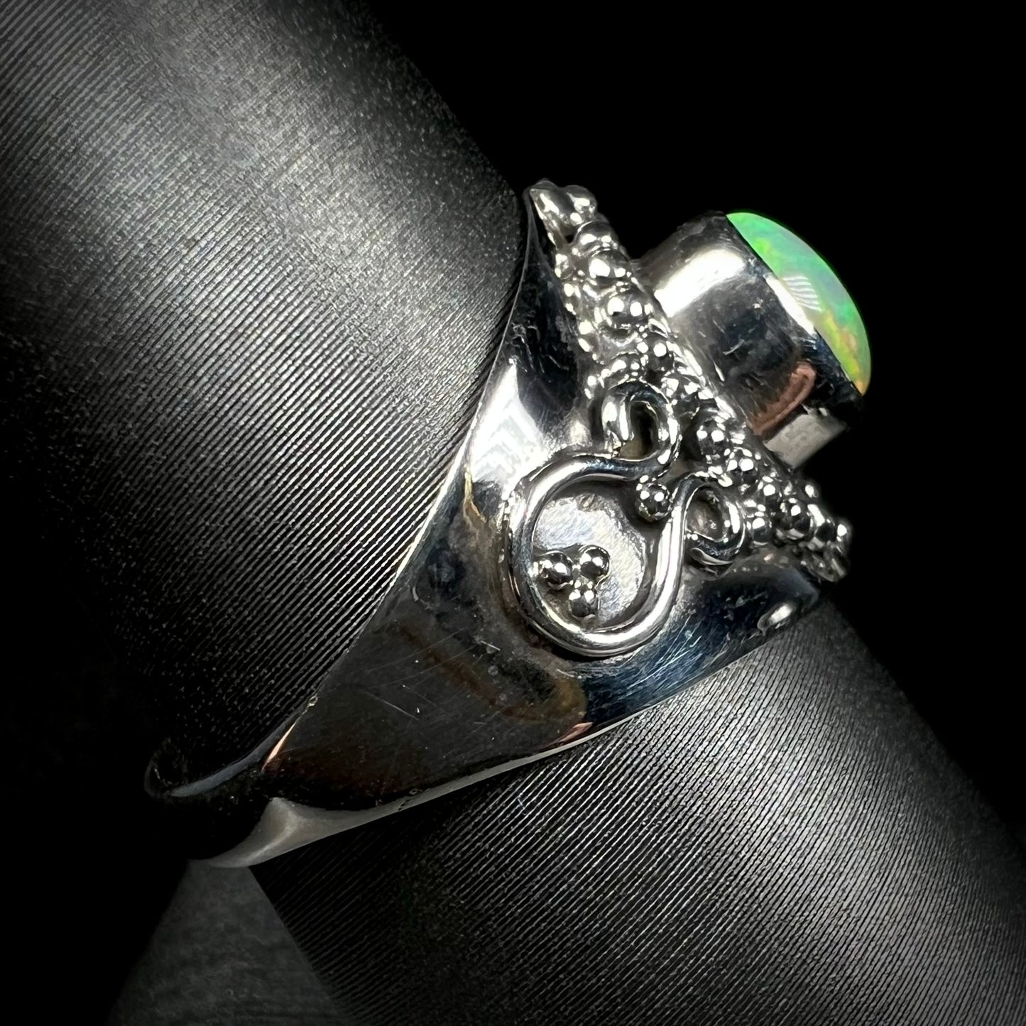 Side view of a silver Boho-style ring mounted with an Ethiopian fire opal.