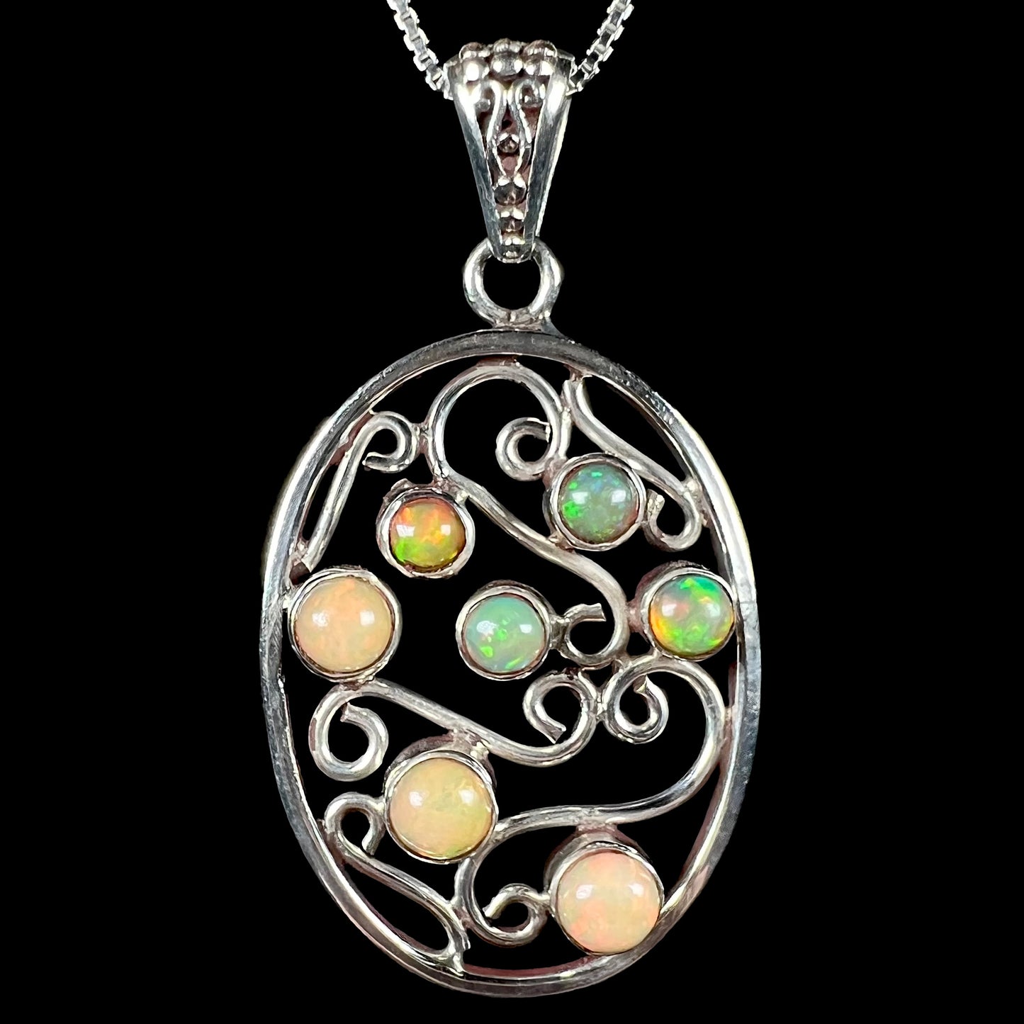 A Boho vintage-style sterling silver Ethiopian opal filigree necklace shown against a black background.