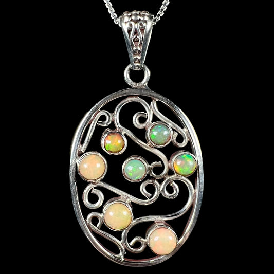 A Boho vintage-style sterling silver Ethiopian opal filigree necklace shown against a black background.